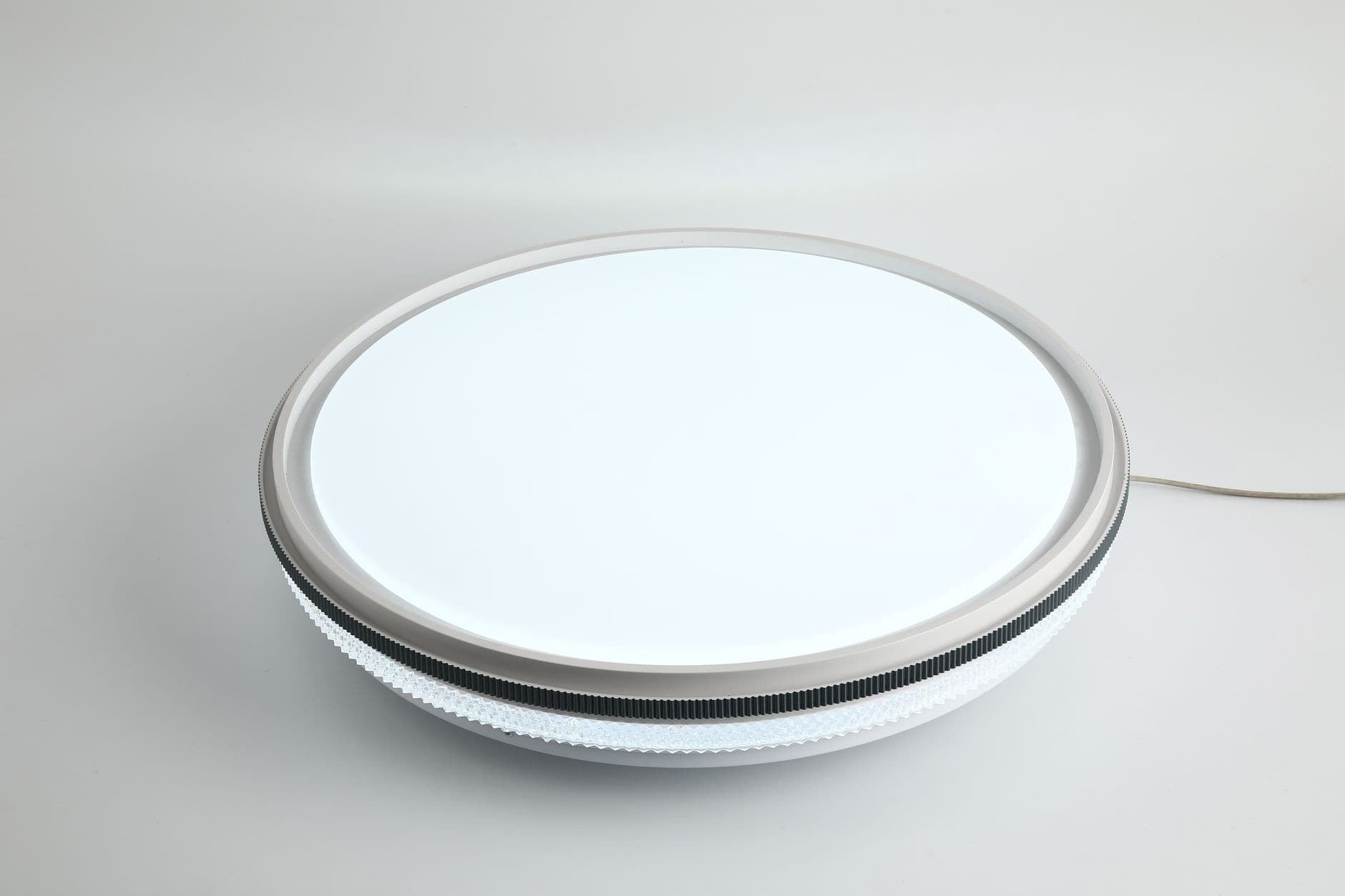 A round flush ceiling light fitting on a plain white background.